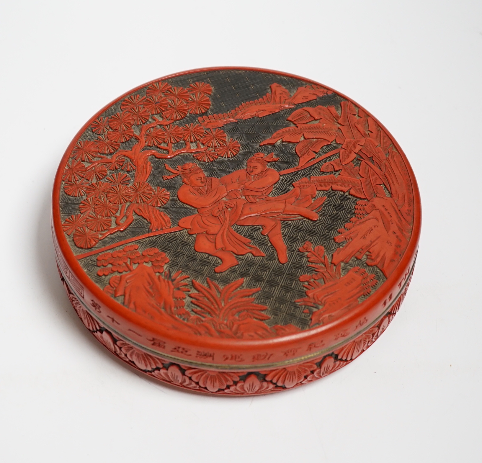 A Chinese cinnabar two colour lacquer box and cover, commemorating 11th Asian Games, Beijing, 20.5cm diameter